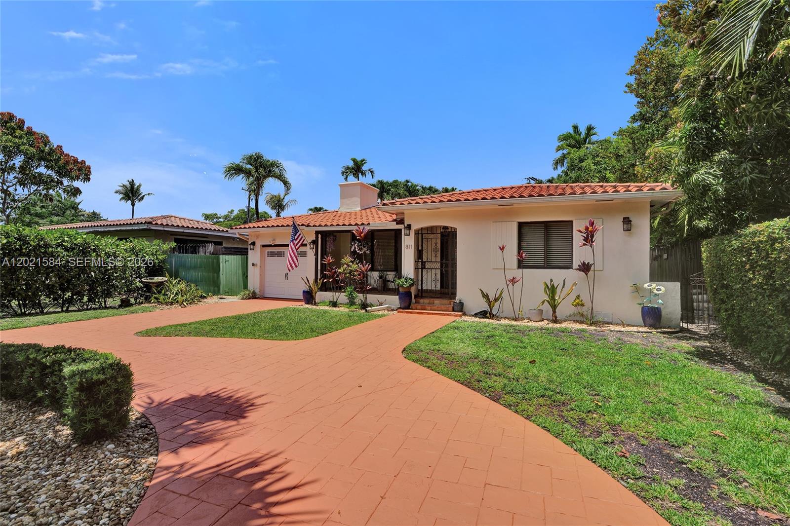811 Northeast 73rd Street Miami, FL 33138 - Photo 3 of 51 a front view of a house with yard and green space