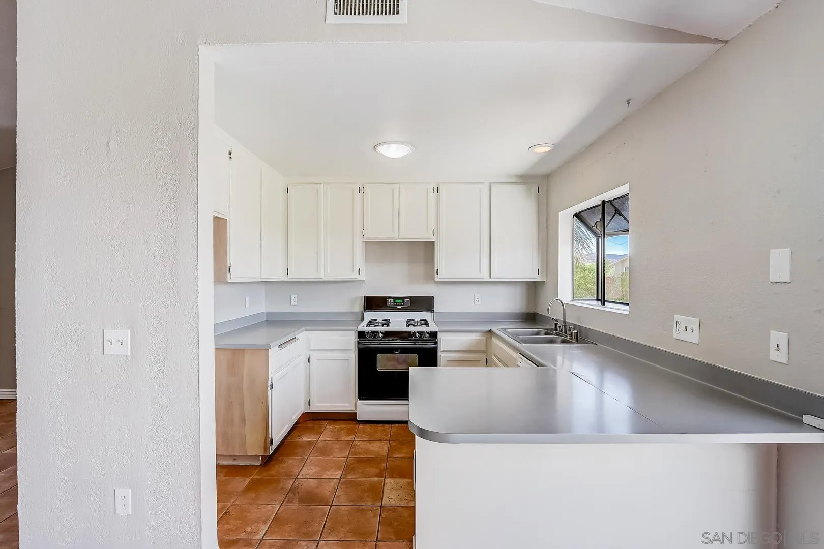 11988 Mountainview Heights Lakeside, CA 92040 - Photo 4 of 26 a kitchen with stainless steel appliances granite countertop a sink stove and refrigerator