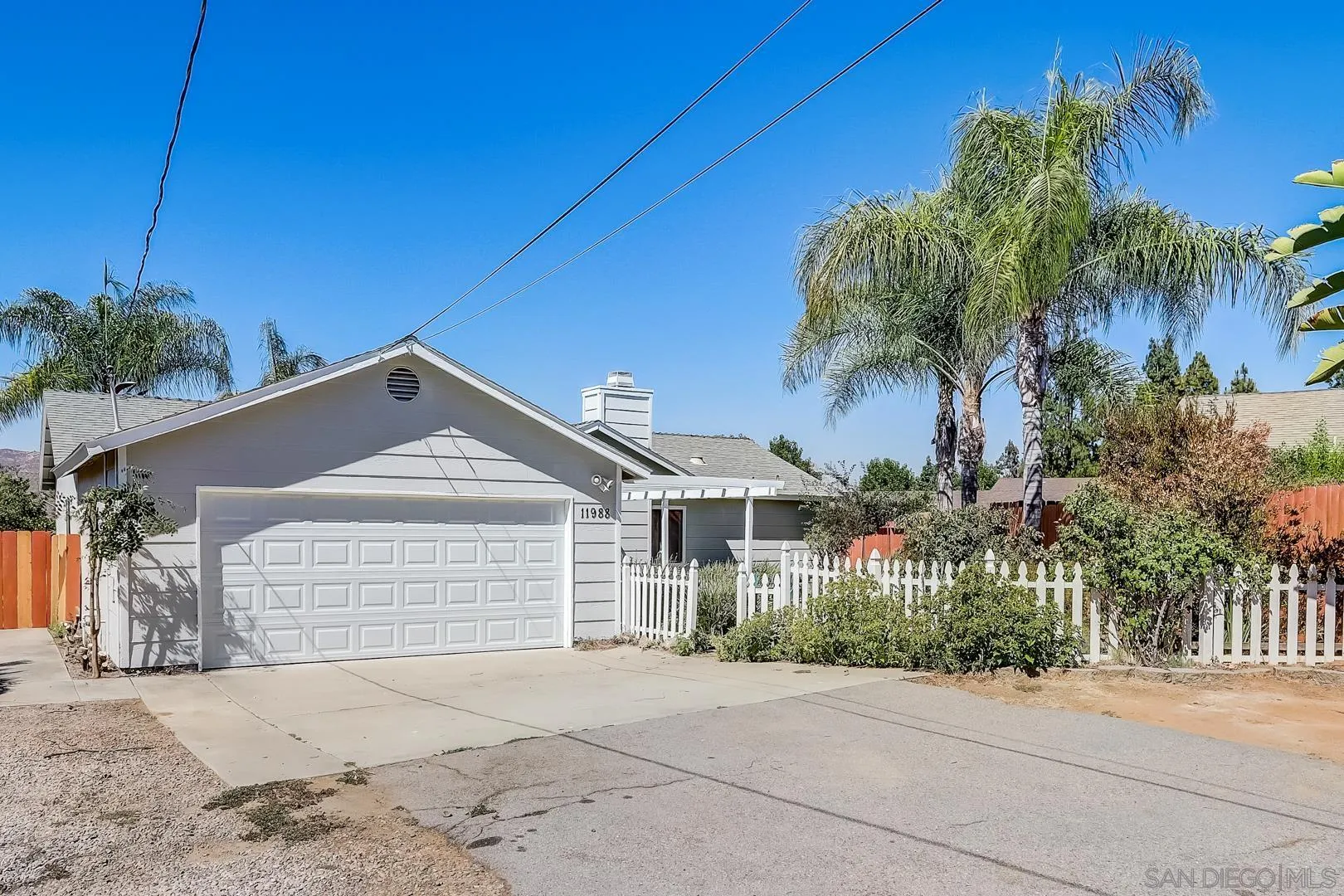11988 Mountainview Heights Lakeside, CA 92040 - Photo 10 of 26 a front view of a house with a yard and garage