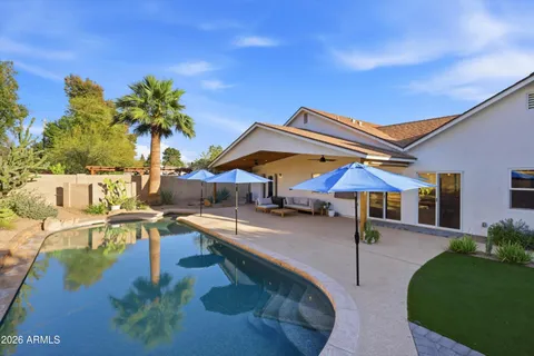 a outdoor living space with furniture and a flat screen tv