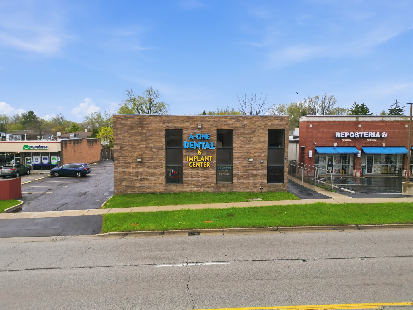 2071 Irving Park Road Hanover Park, IL 60133 - Photo 1 of 53 a view of a brick building next to a yard