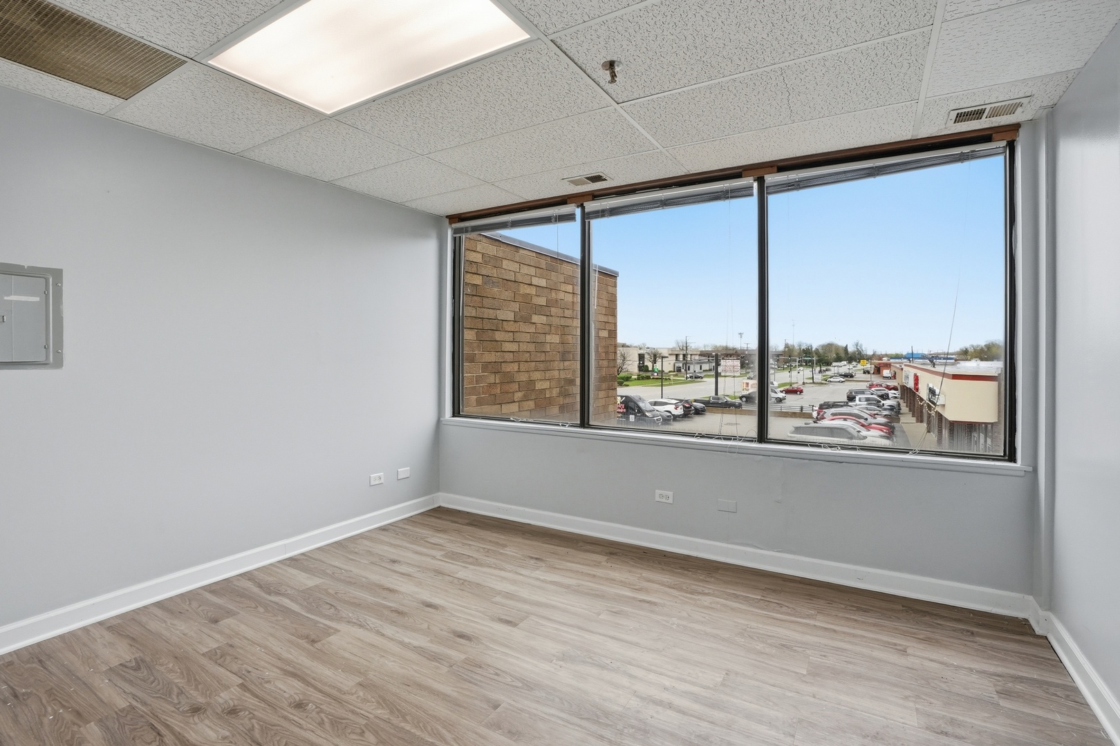2071 Irving Park Road Hanover Park, IL 60133 - Photo 15 of 53 an empty room with wooden floor and windows