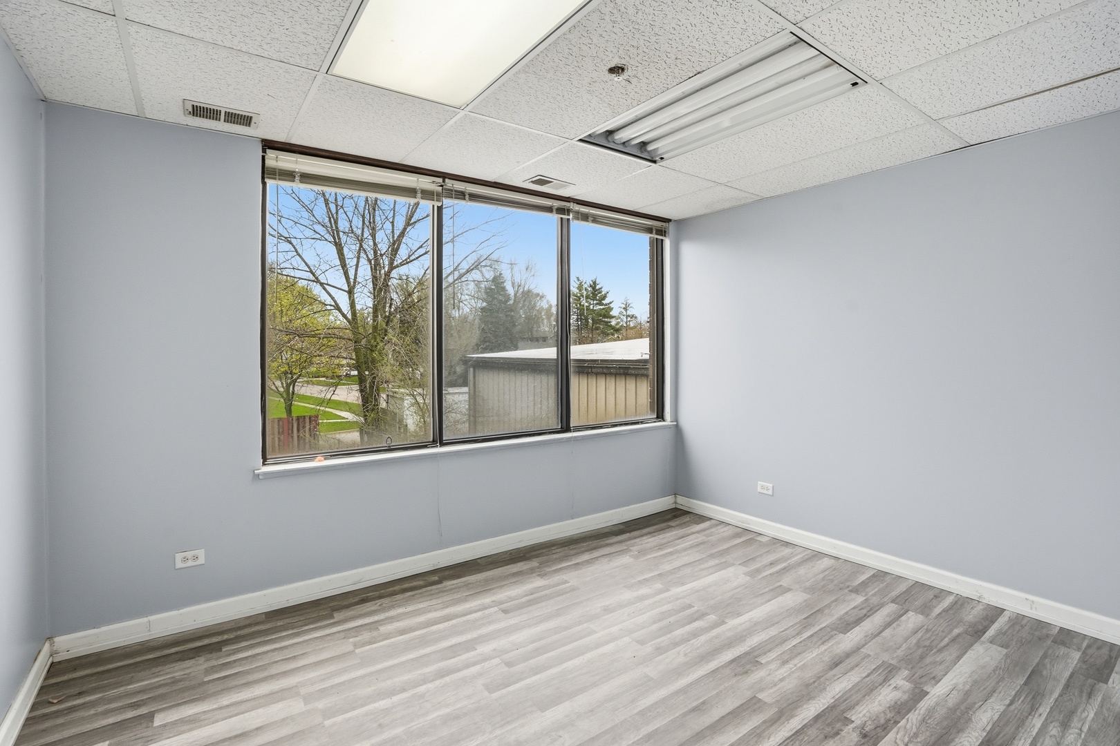 2071 Irving Park Road Hanover Park, IL 60133 - Photo 16 of 53 an empty room with wooden floor and windows