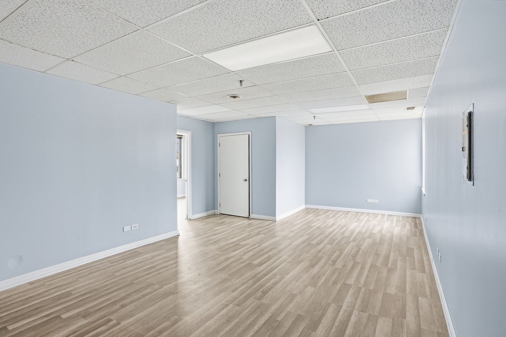 2071 Irving Park Road Hanover Park, IL 60133 - Photo 18 of 53 a view of an empty room with wooden floor