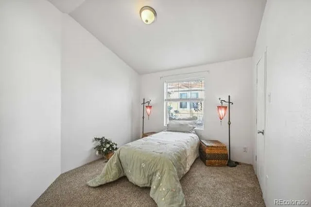 a spacious bedroom with a bed and a window