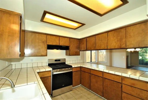 a kitchen with stainless steel appliances granite countertop a sink and a stove