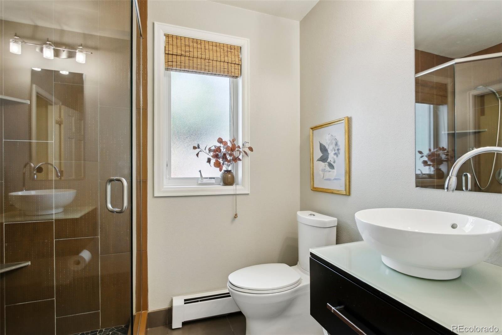 2255 18th Street Boulder, CO 80302 - Photo 13 of 45 a bathroom with a toilet a sink and shower