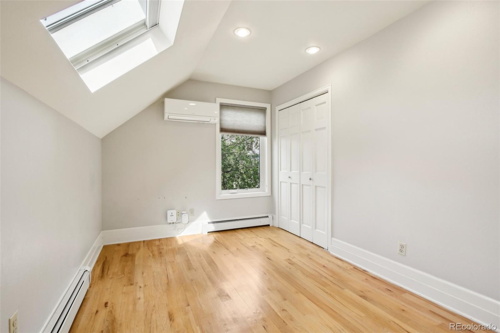 2255 18th Street Boulder, CO 80302 - Photo 18 of 45 an empty room with wooden floor and windows