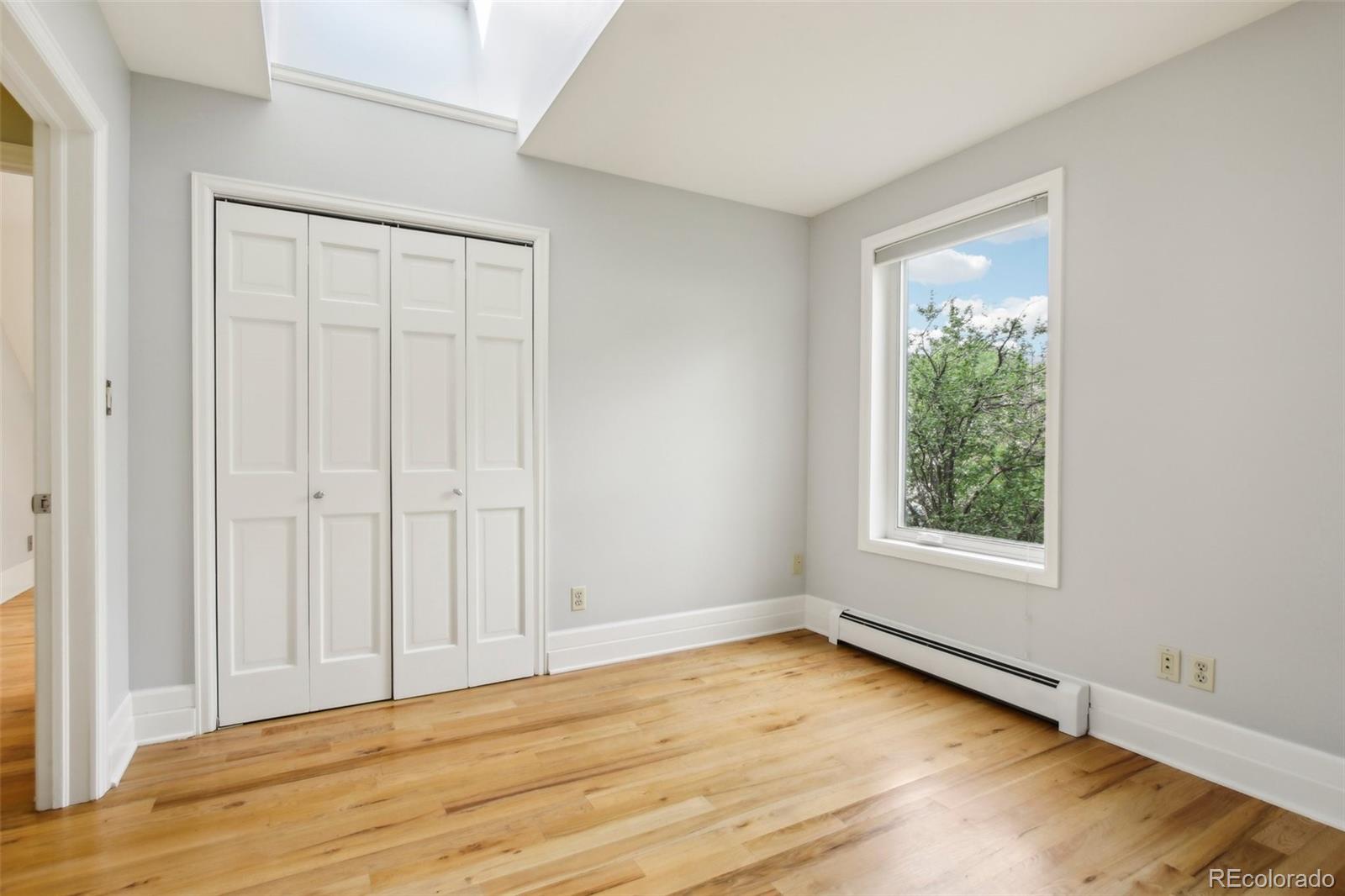 2255 18th Street Boulder, CO 80302 - Photo 21 of 45 an empty room with wooden floor and windows