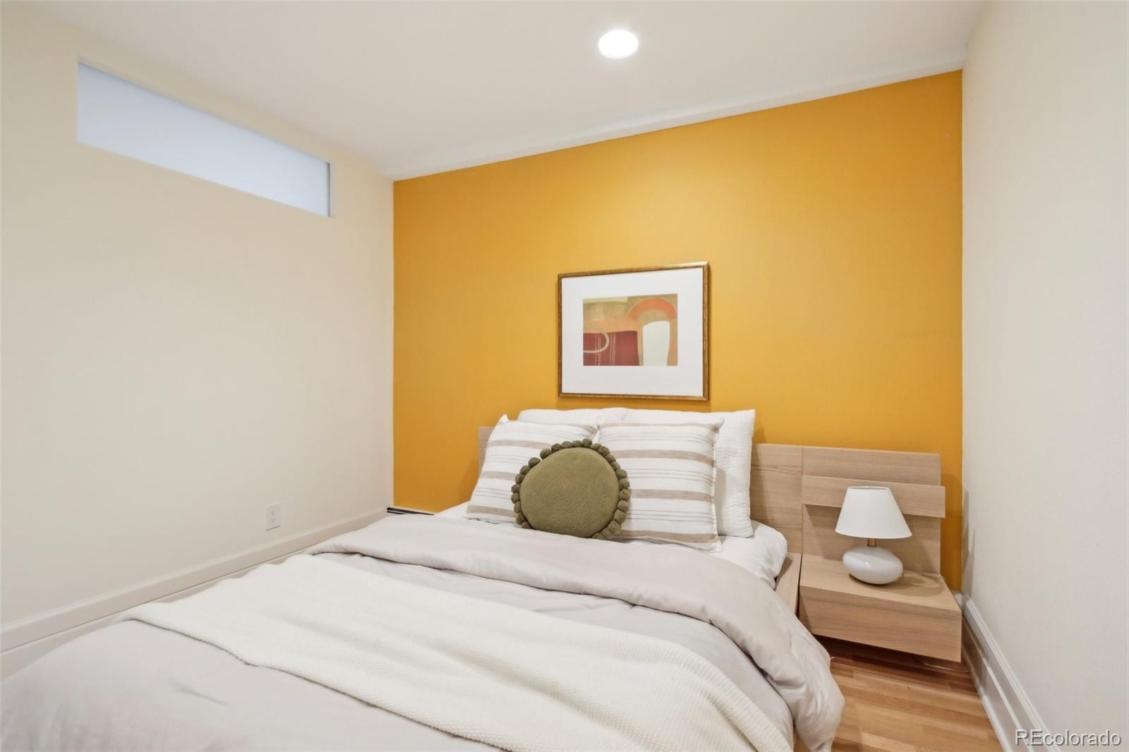 2255 18th Street Boulder, CO 80302 - Photo 26 of 45 a bedroom with a bed and a painting on the wall