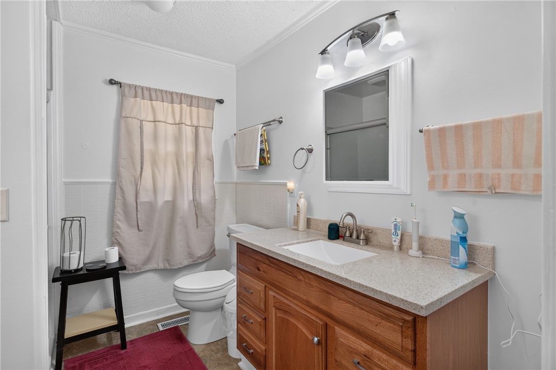 230 Dickard Road Seneca, SC 29672 - Photo 13 of 25 A well-appointed bath features crown molding and a practical vanity with counter space.