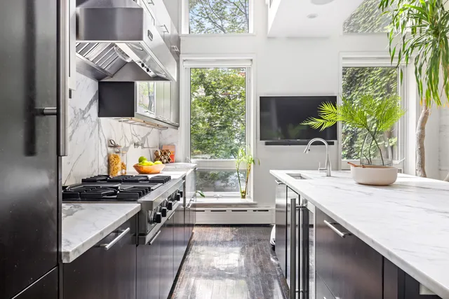 a kitchen with a table chairs stove and cabinets