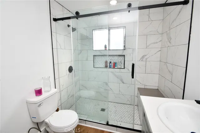 a bathroom with a toilet and a shower