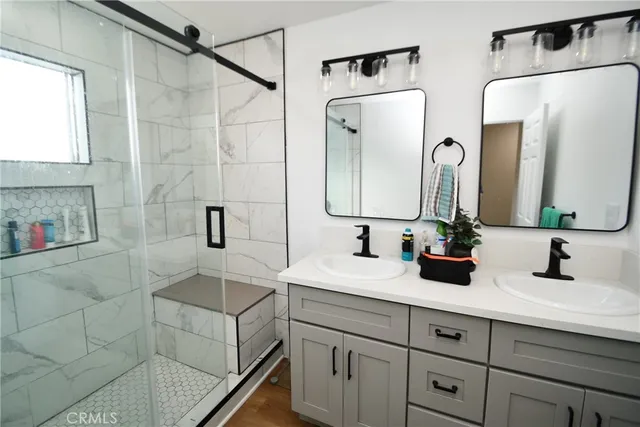 a bathroom with a double vanity sink mirror and double
