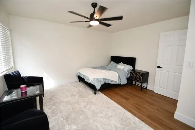 a bedroom with a bed and a couch