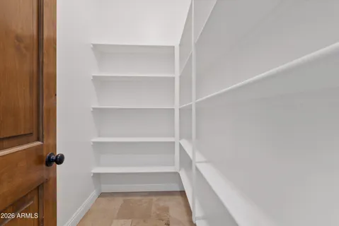 a view of walk in closet with empty racks