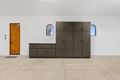 a spacious bedroom with a bed and glass door