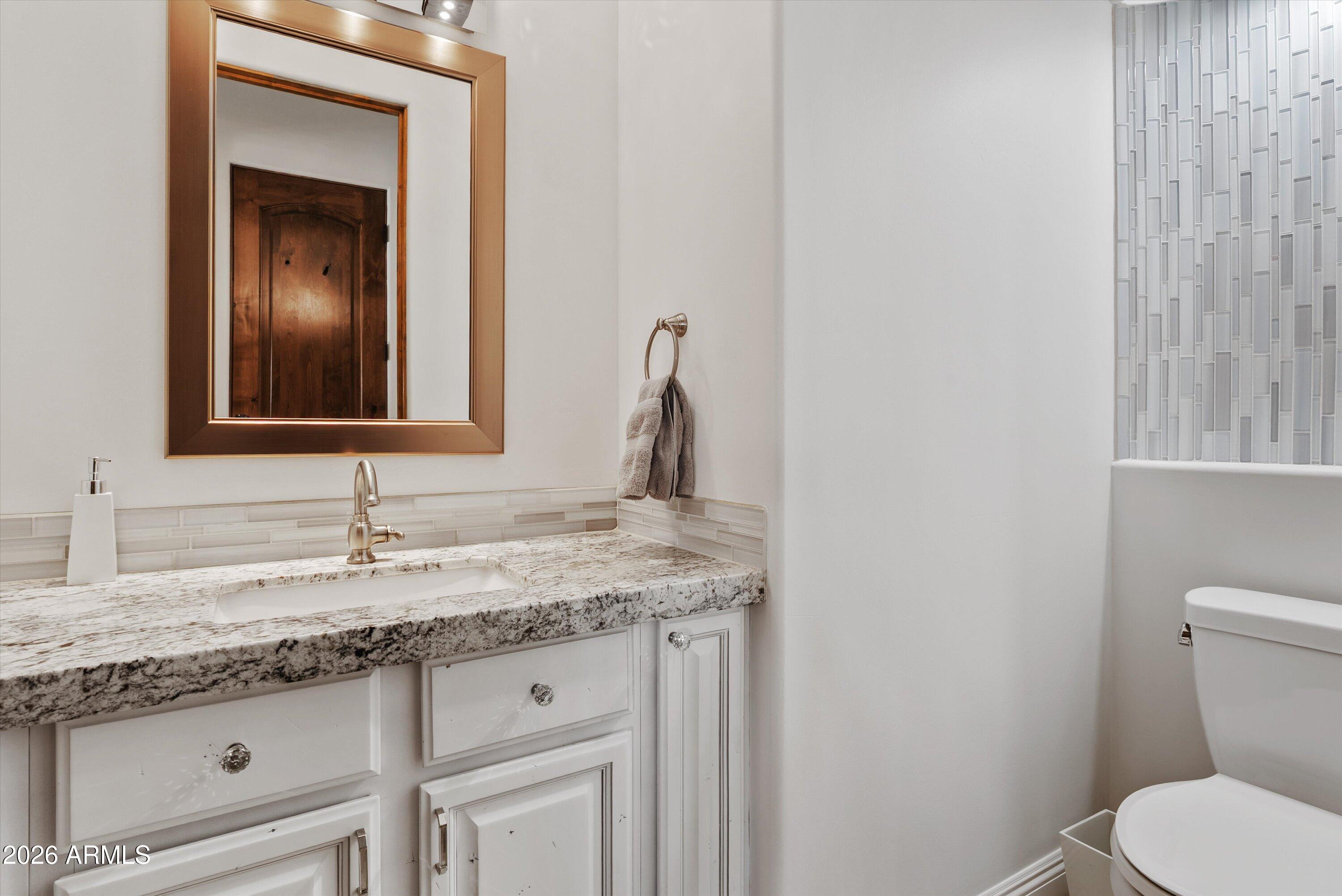 1617 West Maddock Road Phoenix, AZ 85086 - Photo 32 of 50 a bathroom with a granite countertop sink vanity and toilet