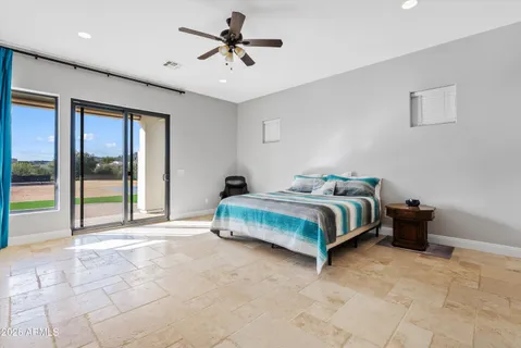 a bedroom with a large bed and a flat screen tv