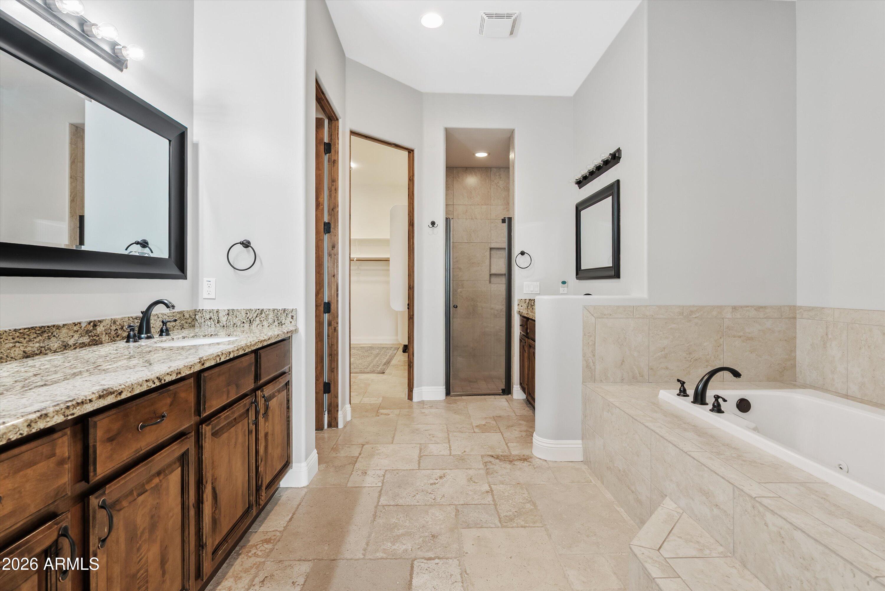 1617 West Maddock Road Phoenix, AZ 85086 - Photo 36 of 50 a spacious bathroom with a tub sink and mirror