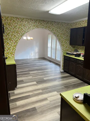 a kitchen with a wooden floor and a stove