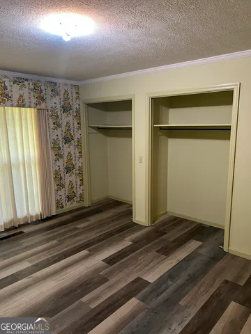 a view of a livingroom with wooden floor and a window