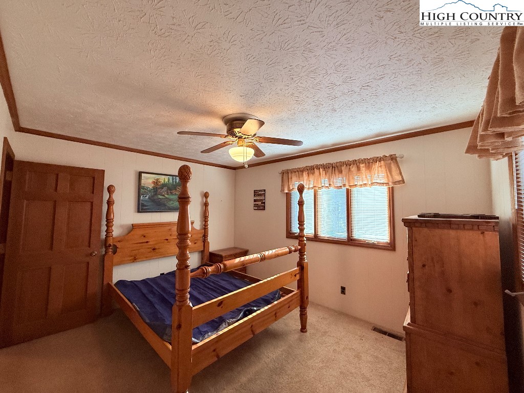 154 Breezy Lane Deep Gap, NC 28618 - Photo 15 of 46 a bedroom with furniture and window