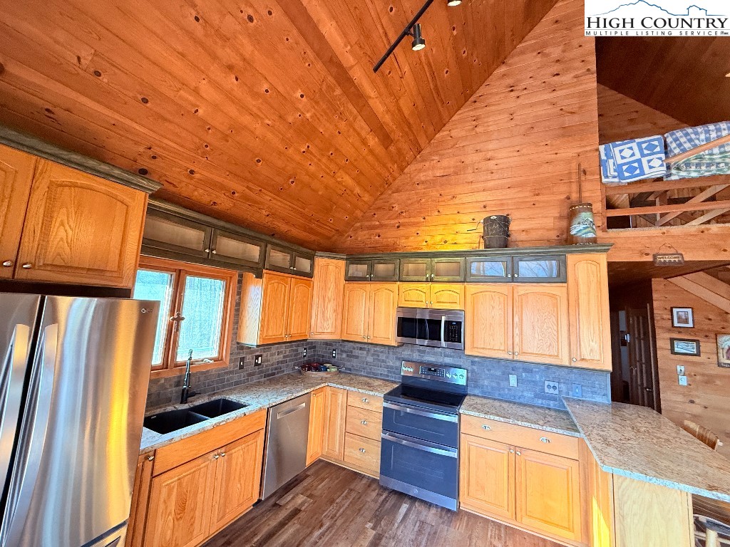 154 Breezy Lane Deep Gap, NC 28618 - Photo 5 of 46 a kitchen with stainless steel appliances granite countertop a sink and a stove