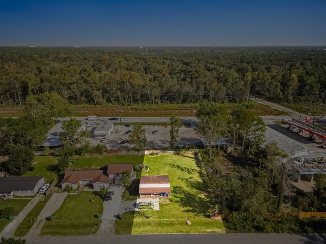 an aerial view of a house with a yard