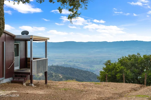 a dinning area with chairs and window