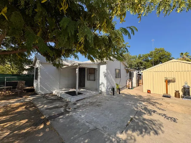 a backyard of a house with yard and outdoor seating