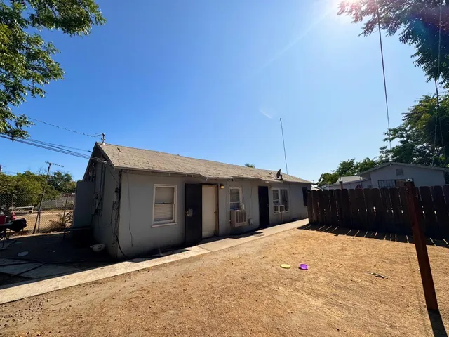 a front view of house with a garden