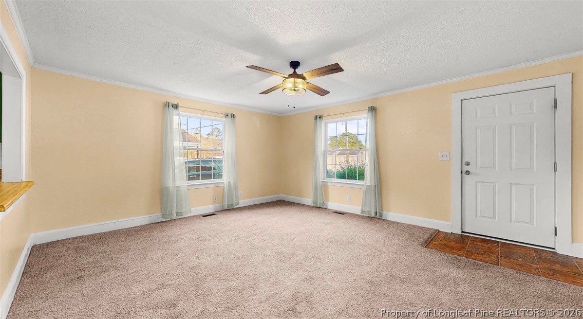 106 County Avenue Dunn, NC 28334 - Photo 12 of 24 an empty room with windows and fan
