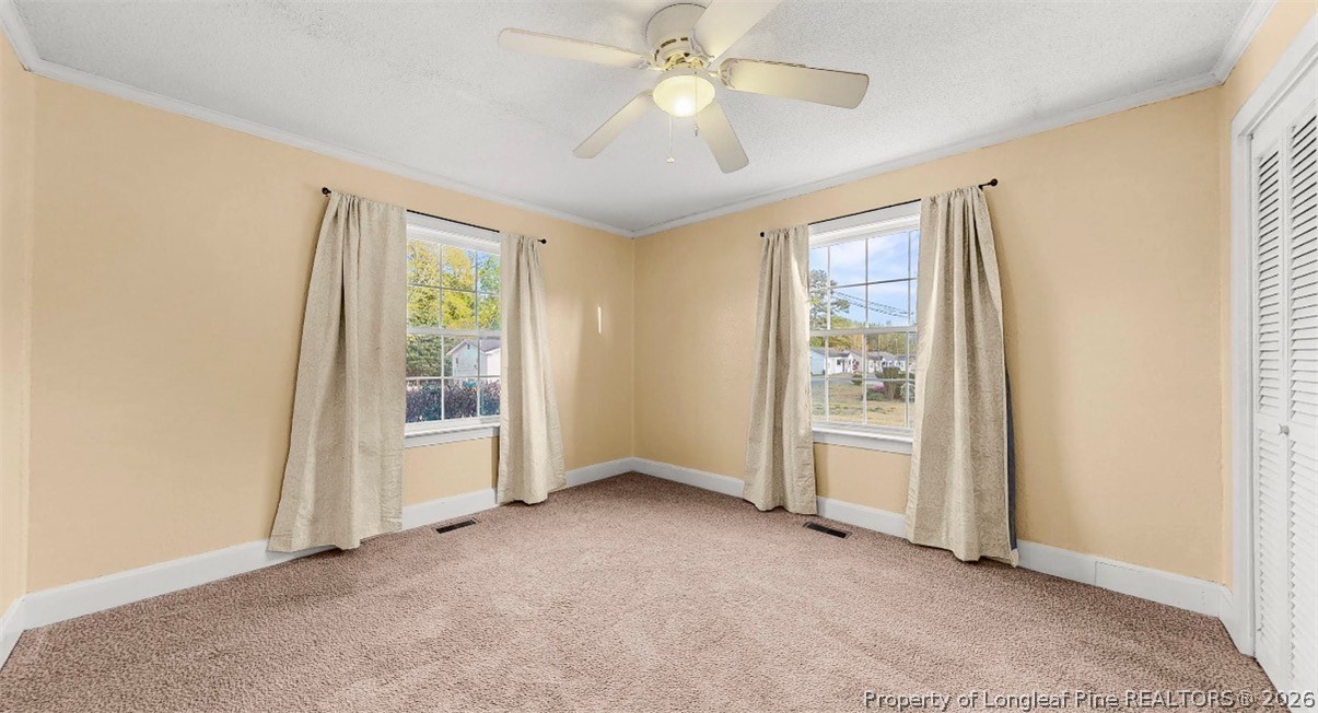 106 County Avenue Dunn, NC 28334 - Photo 14 of 24 an empty room with windows and fan