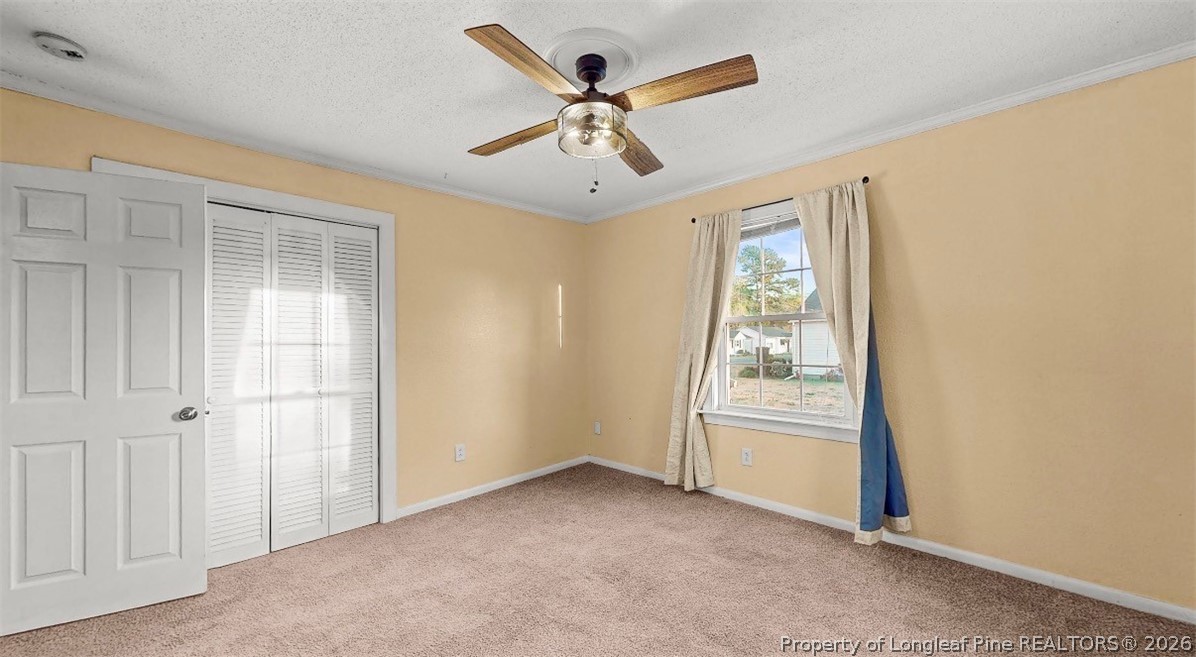 106 County Avenue Dunn, NC 28334 - Photo 17 of 24 an empty room with windows and ceiling fan