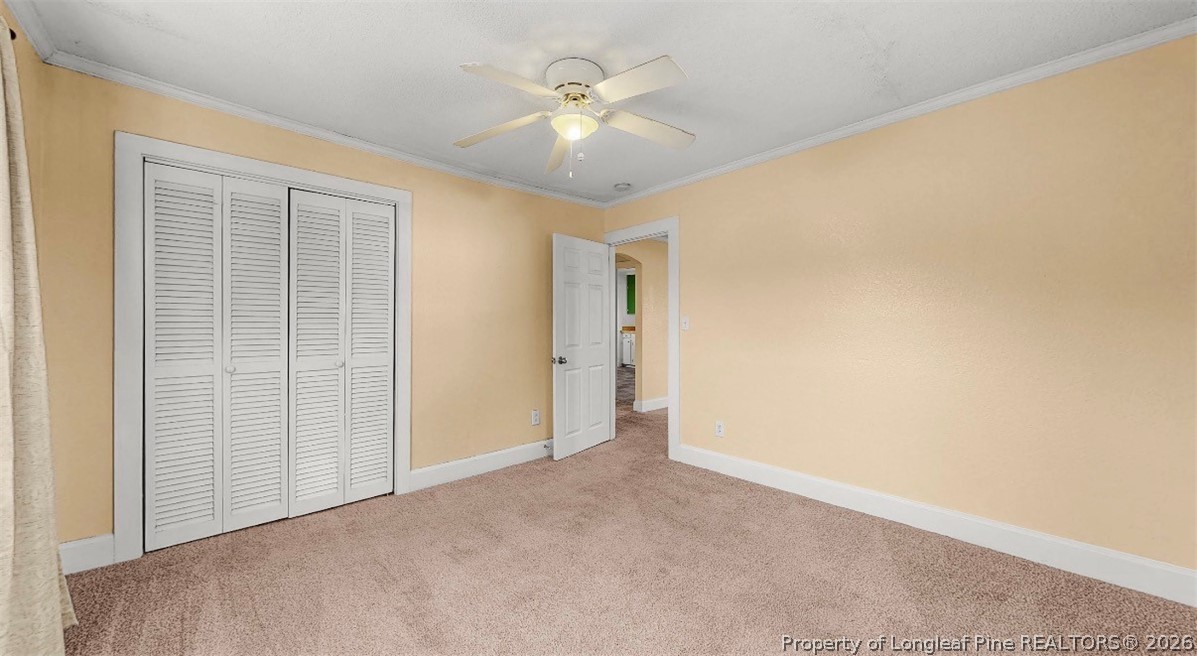 106 County Avenue Dunn, NC 28334 - Photo 20 of 24 an empty room with a ceiling fan and a window