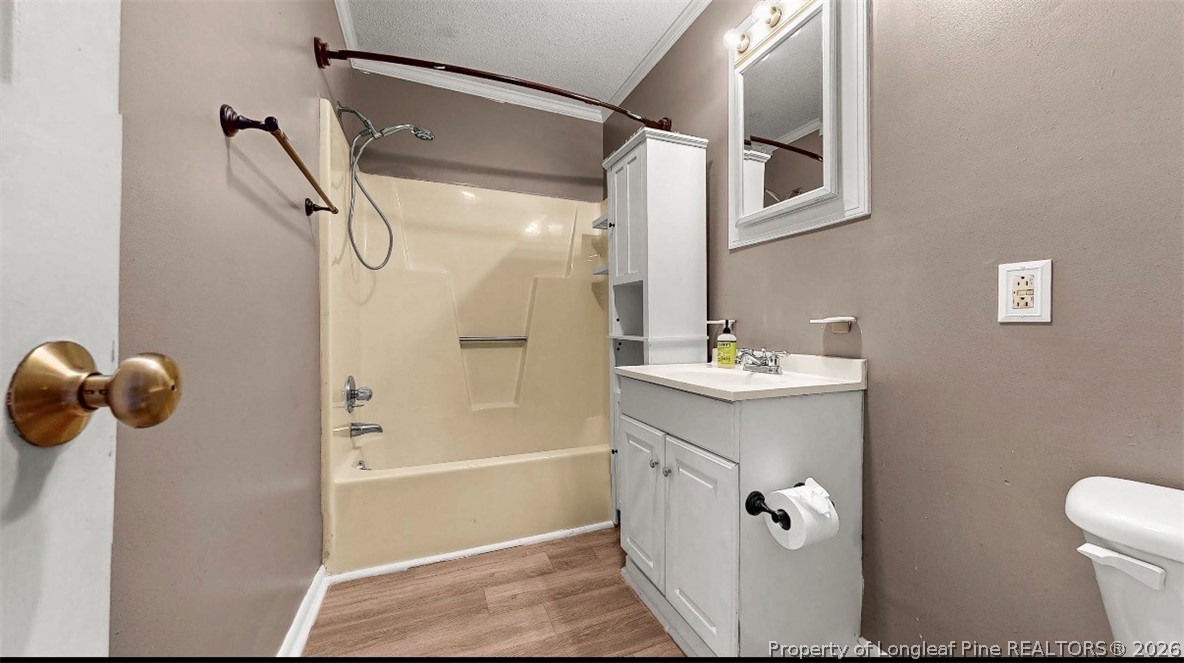 106 County Avenue Dunn, NC 28334 - Photo 23 of 24 a bathroom with a sink a mirror a toilet and shower