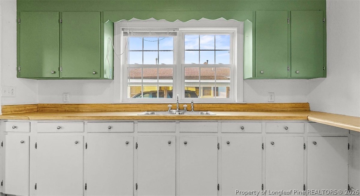 106 County Avenue Dunn, NC 28334 - Photo 9 of 24 a kitchen with a sink and cabinets
