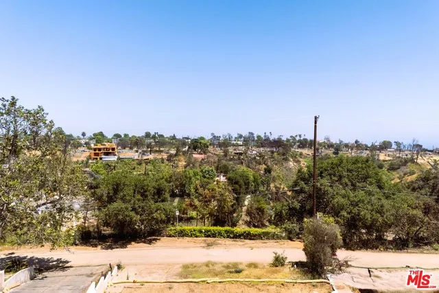 a view of a yard with a snow on the road