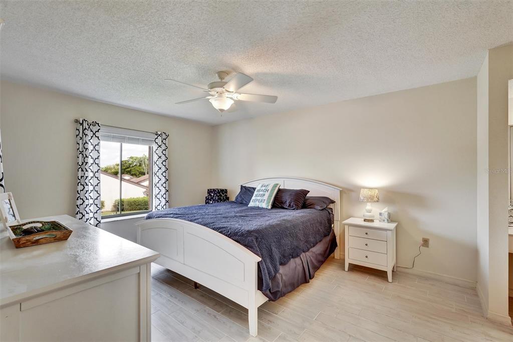 6221 Timberlake Drive, Unit C10 Sarasota, FL 34243 - Photo 14 of 27 a bedroom with a bed and a table in it