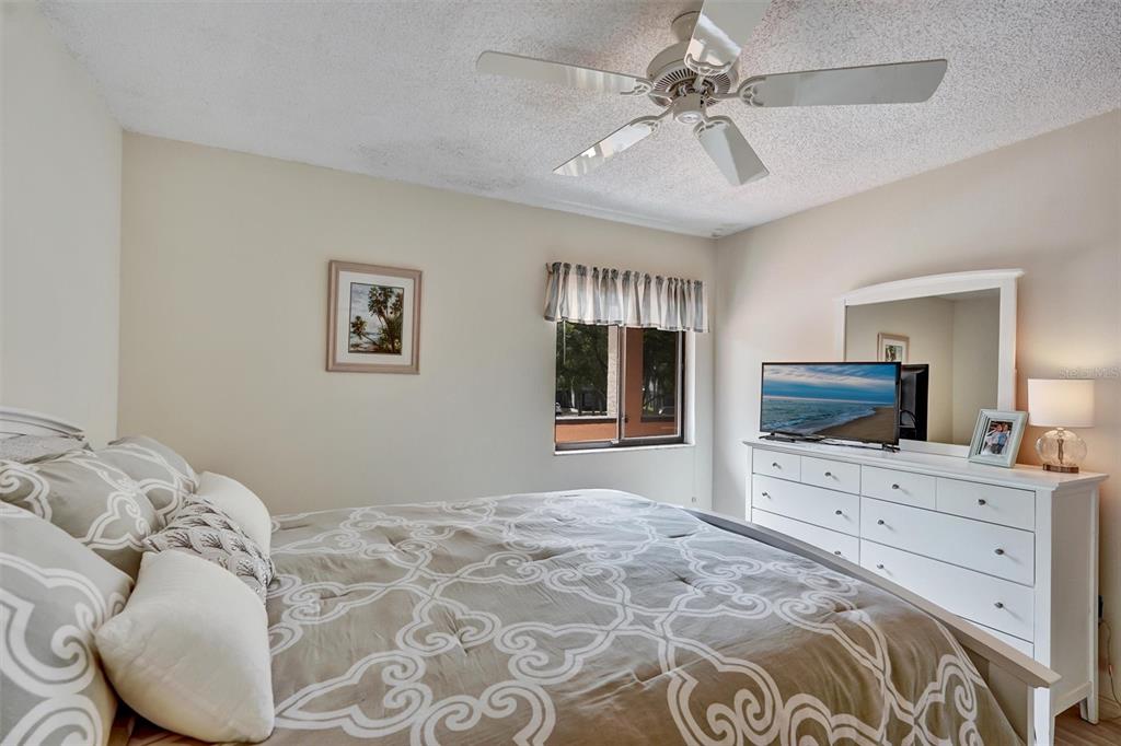6221 Timberlake Drive, Unit C10 Sarasota, FL 34243 - Photo 22 of 27 a bedroom with a bed and a flat screen tv