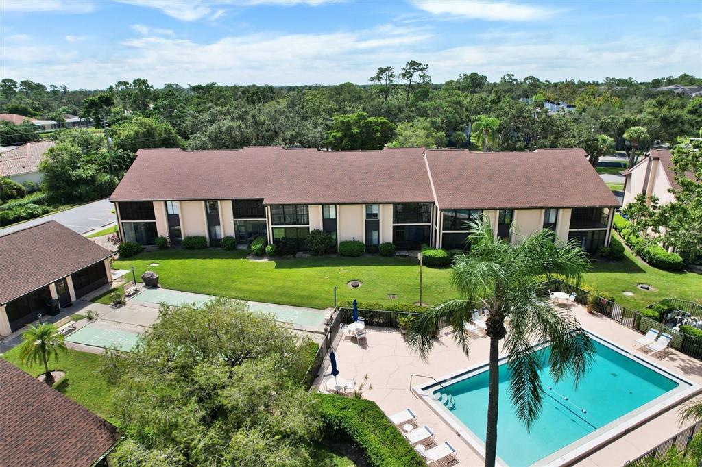 6221 Timberlake Drive, Unit C10 Sarasota, FL 34243 - Photo 3 of 27 a view of house with garden and a swimming pool