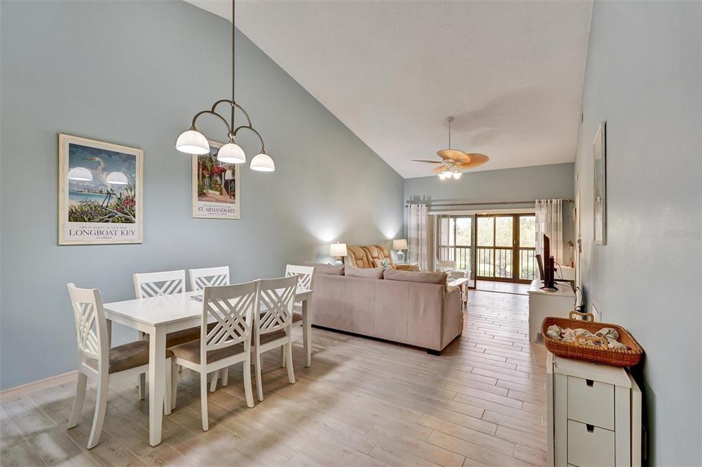 6221 Timberlake Drive, Unit C10 Sarasota, FL 34243 - Photo 5 of 27 a view of a dining room with furniture and chandelier