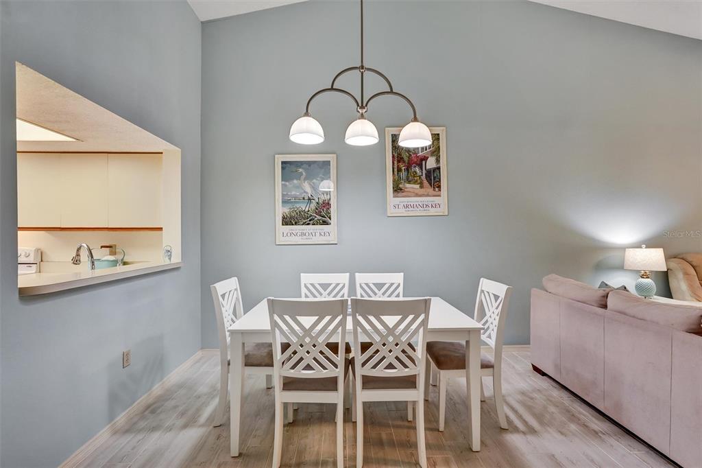6221 Timberlake Drive, Unit C10 Sarasota, FL 34243 - Photo 9 of 27 a view of a dining room with furniture and wooden floor