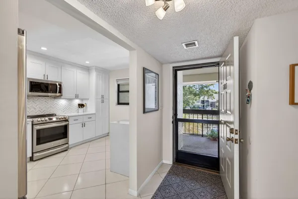 a kitchen with stainless steel appliances granite countertop a refrigerator and a stove top oven