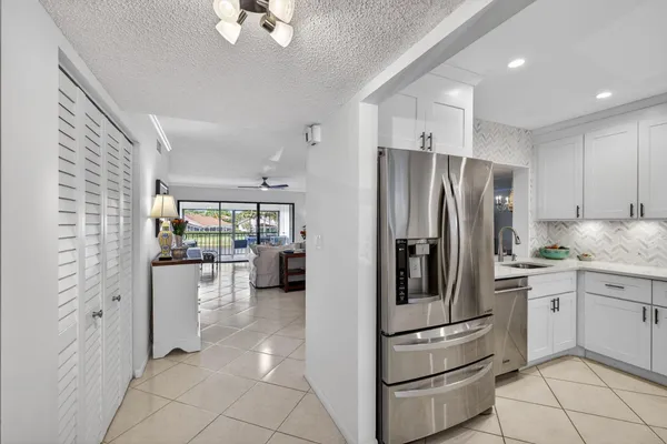a kitchen with stainless steel appliances a refrigerator sink and stove
