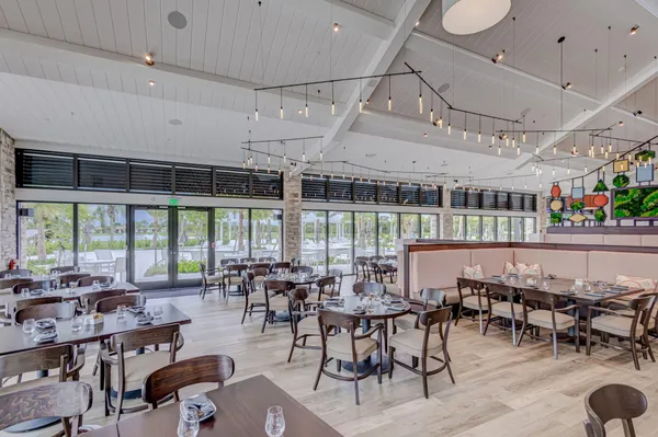 an aerial view of residential houses with outdoor space and ocean view