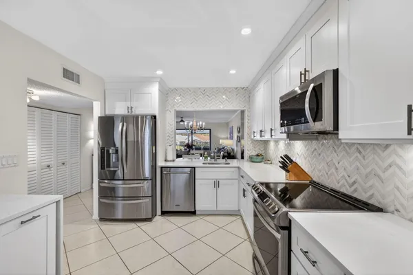 a kitchen with a refrigerator and a sink