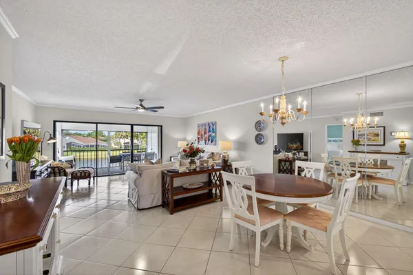 a kitchen with granite countertop white cabinets and chairs