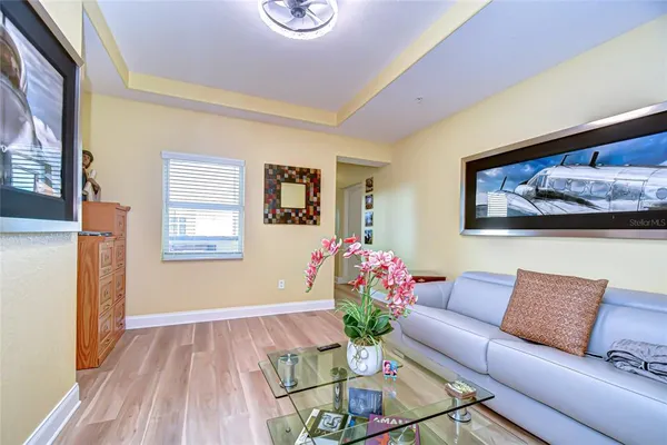 a living room with furniture and flowers